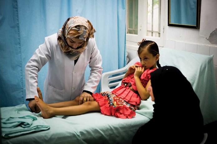 A young girl receiving physiotherapy due to a shrapnel wound at Al Ahli Hospital in Gaza City.