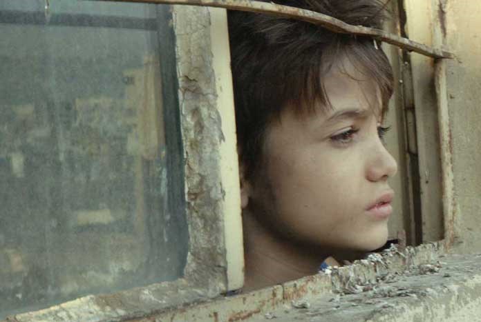 A young looking out of a window – a still from the film 'Capernaum'.