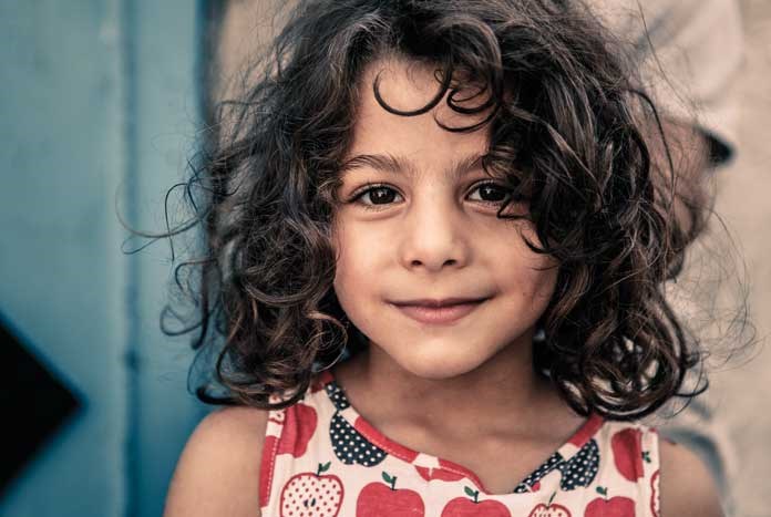 A young girl from a refugee camp in Bethlehem poses for the camera.