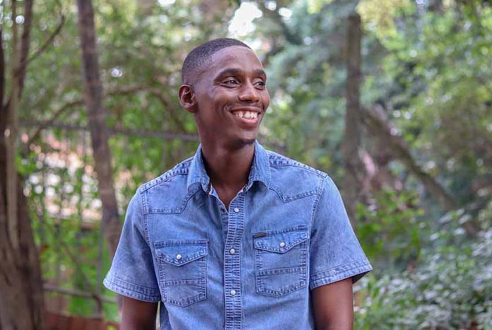 A male Umthombo staff member smiling.