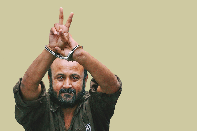 Marwan Barghouti holding his hand-cuffed hands above his head.