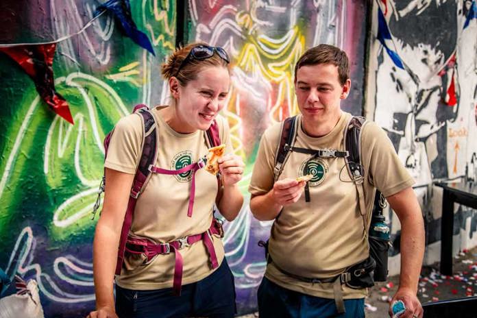 Naomi and partner Robin, enjoying some Pizza at the Walled Off Hotel courtesy of Banksy.