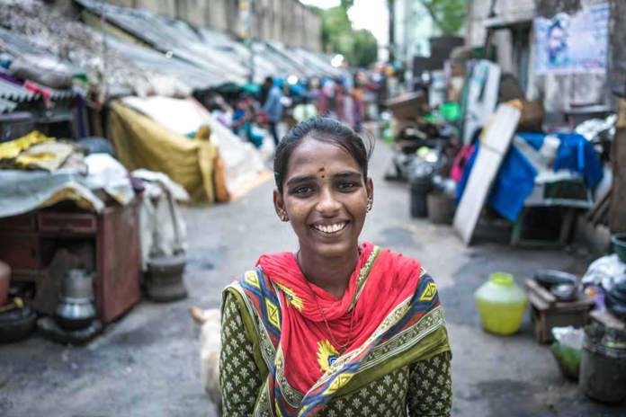 A young women smiles on the streets of Chennai, India