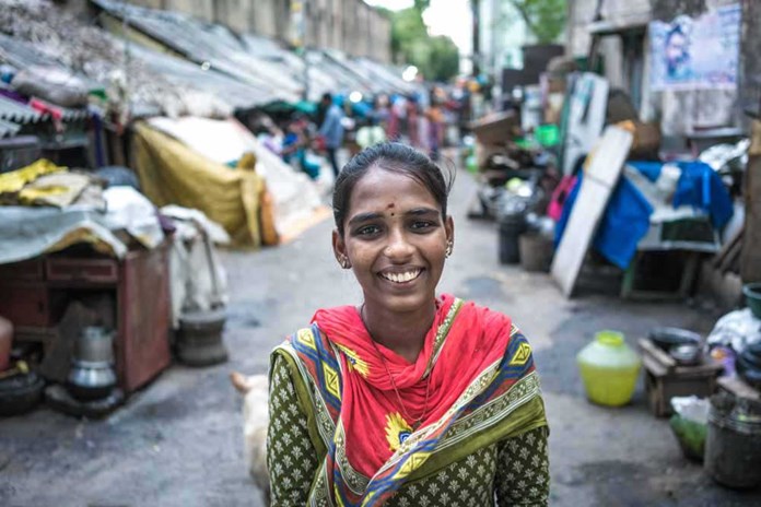A young women smiles on the streets of Chennai, India