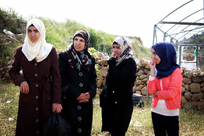 A family of women standing in their garden in Palestine.