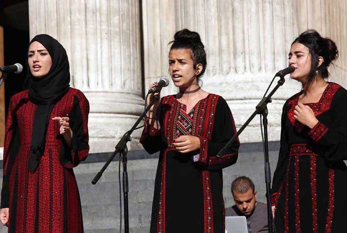 Young Palestinian women from Bethlehem singing on the steps of St Paul's Cathedral in London.