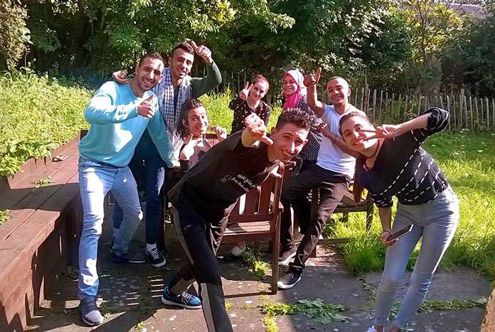 A group of young Palestinian people posing for the camera.