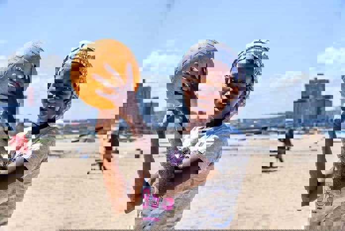 A young women playing beach volleyball on the beach in Durban, South Africa.