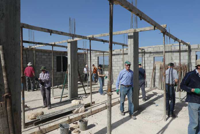 A group of volunteers from the UK rebuilding a demolished Palestinian Home.