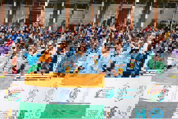 Team celebrating behind the flag of India after winning the Street Child Cricket World Cup at Lord's.