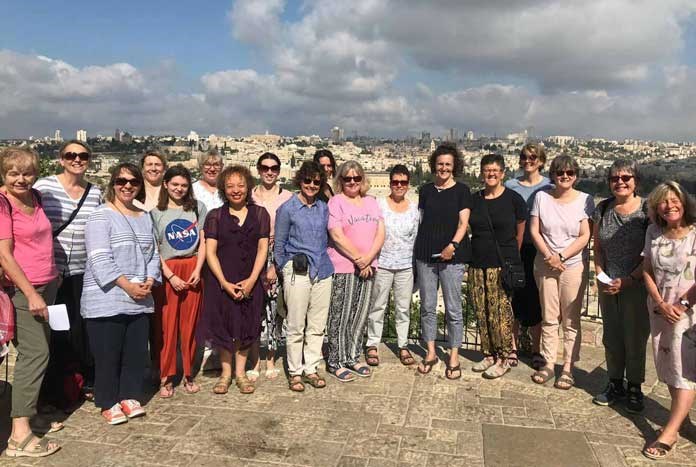 A group of women from the UK standing at the top of the Mount of Olives over-looking the Old City of Jerusalem.