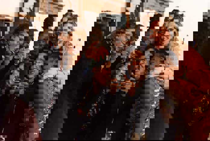 A group of women laughing while taking a Selfie.