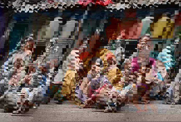 An Indian family sit outside their 'house' on the pavement on Barracks Road, Chennai.