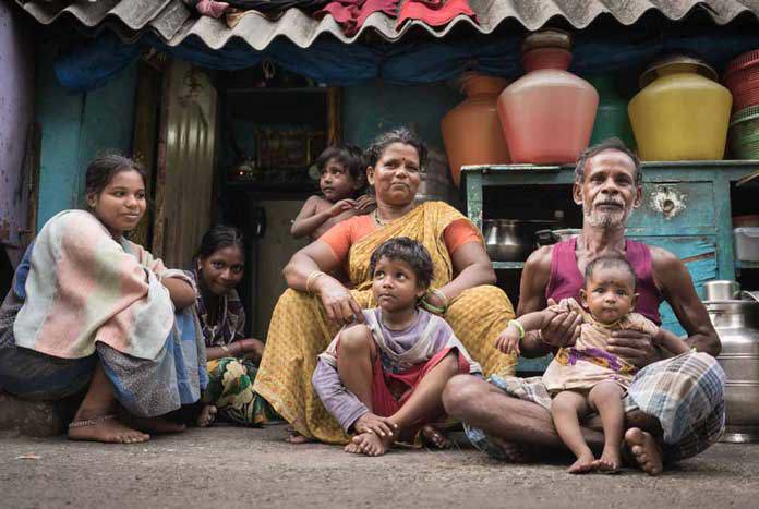 An Indian family sit outside their 'house' on the pavement on Barracks Road, Chennai.