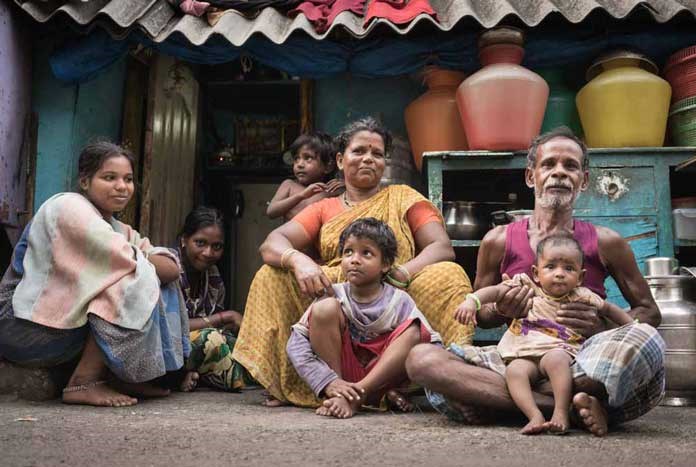 An Indian family sit outside their 'house' on the pavement on Barracks Road, Chennai.