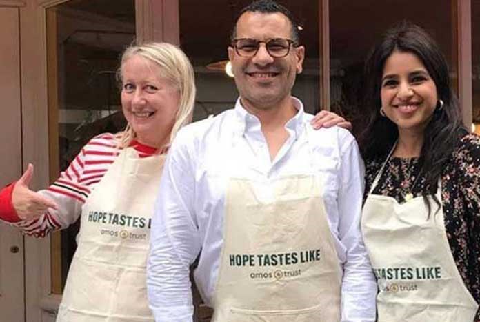 Sami Tamimi from Ottolenghi and friends wearing Amos Trust's 'Hope Tastes Like' aprons.