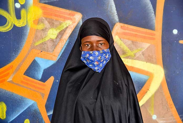 A South African women wearing a face mask.