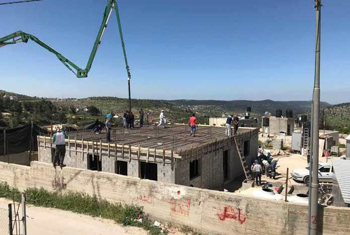 A demolished Palestinian home being rebuilt in the West Bank.