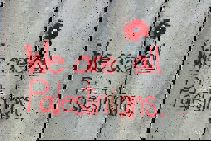 Graffiti on the Israeli Separation Wall reads, "We Are All Palestinians"