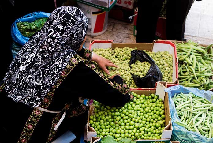 A Palestinian women selling fresh chickpeas at a Bethlehem market.
