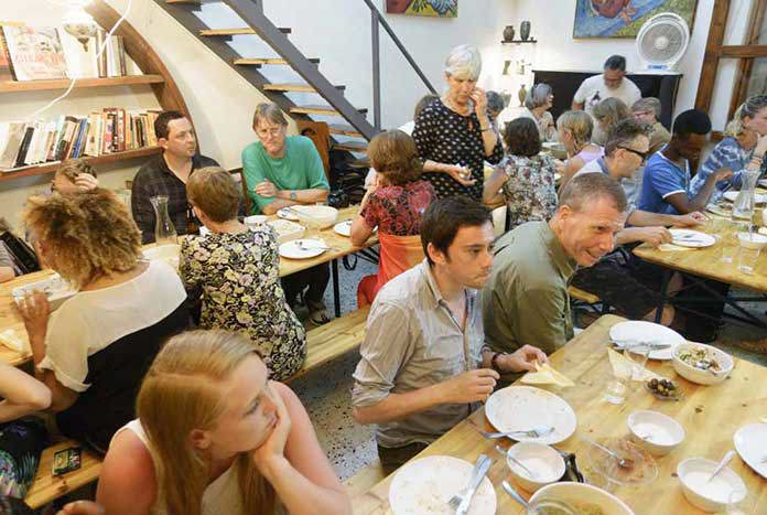 A group of UK visitors enjoying a meal at Liwan Culture Cafe in Nazareth, Palestine