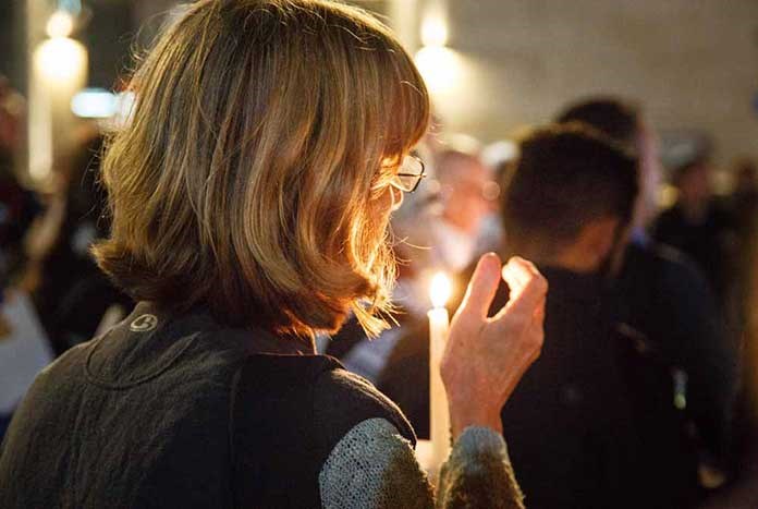 A women holding a candle in Manger Square, Bethlehem