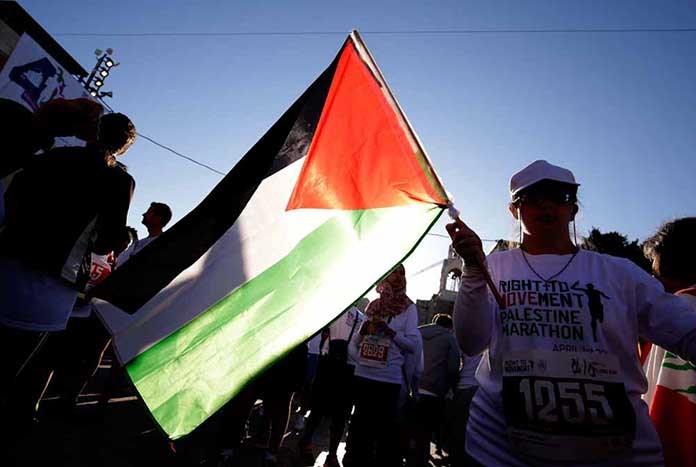 A Palestinian flag being waved at the start of the Palestine Marathon.