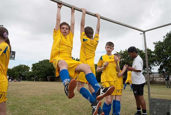 Members of the Ukrainian team hanging from the goal posts at the Street Child World Cup.