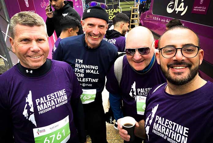Nive Hall and Chris Rose from Amos Trust, John Wroe from Street Child United and Elias D'eis from Holy Land Trust in Bethlehem preparing to Run The Wall.