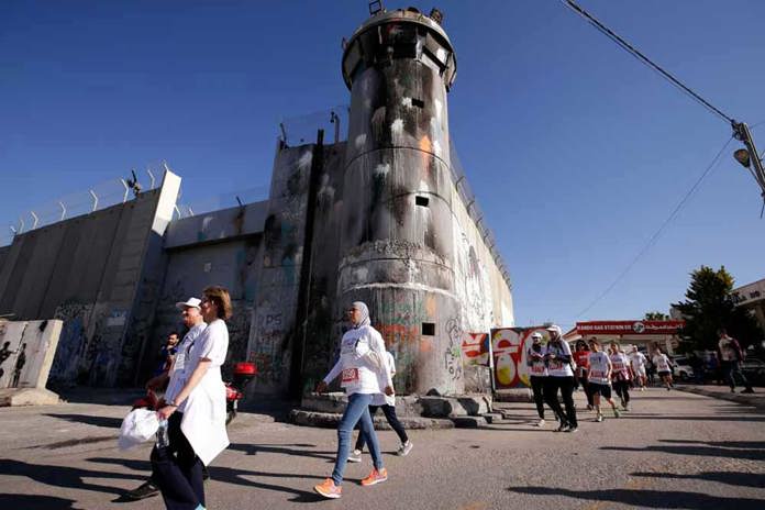 Participants in the Palestine Marathon walking through Bethlehem.