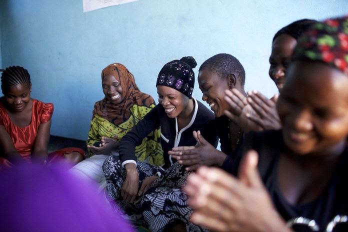 A group of women laughing together in rural Tanzania.