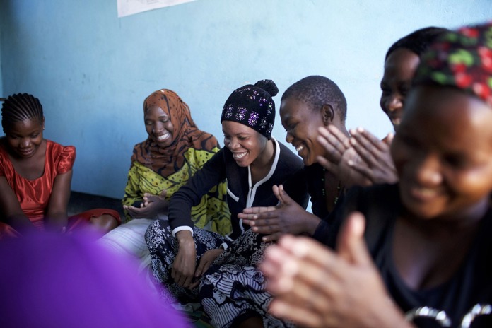 A group of women laughing together in rural Tanzania.