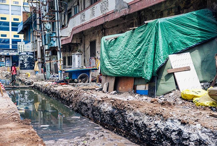 An open sewer in front of a pavement-dwelling community in India.