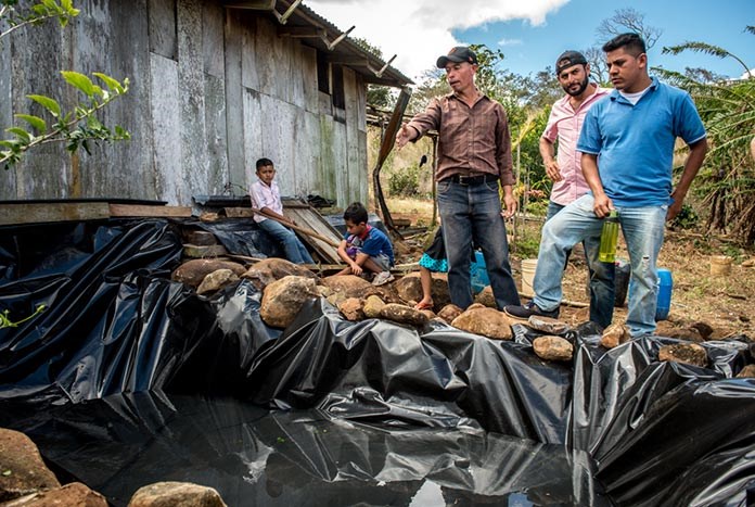 A group of Nicaraguan men building a micro-dam.