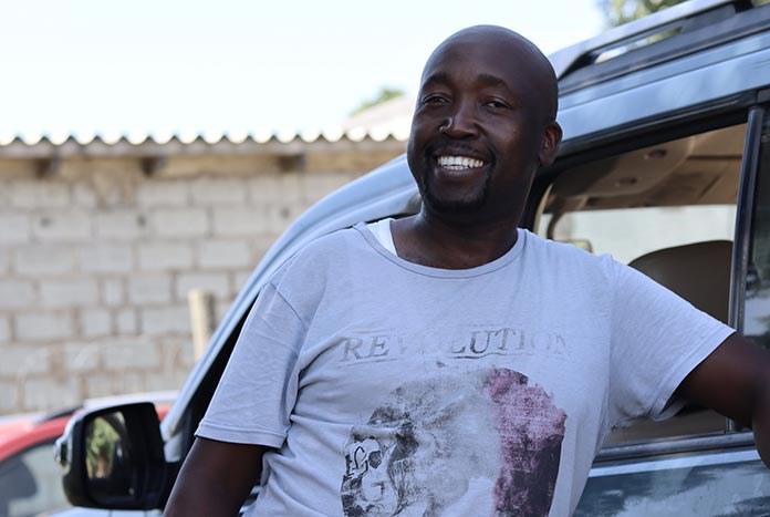 A middle-aged South African man smiling.