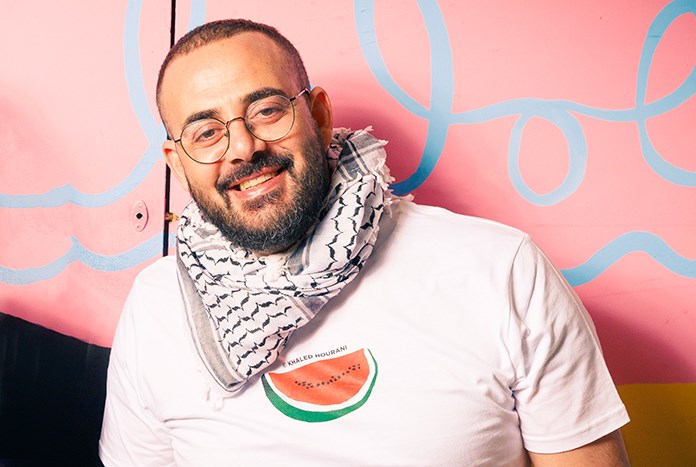 A Palestinian man wearing a watermelo T-shirt design by Khaled Hourani.