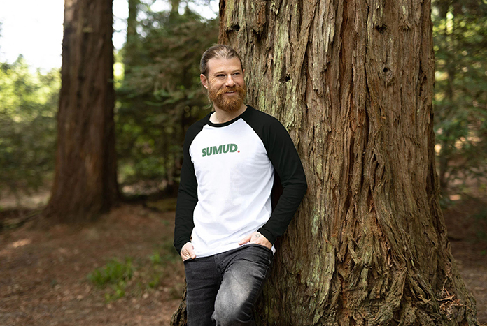 A young man wears an Amos Trust baseball shirt.