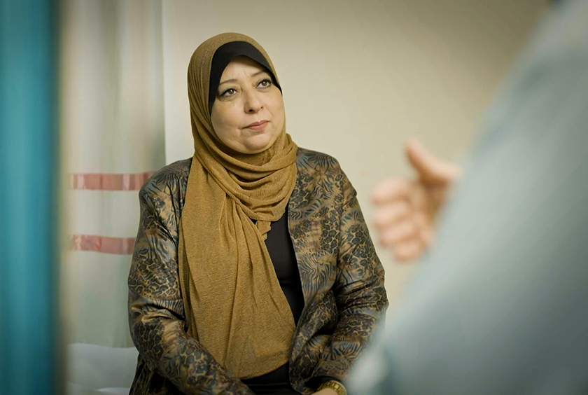 A Gazan woman speaks with her doctor.
