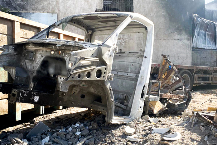 A burnt out hospital vehicle in the grounds of Al Ahli Baptist Hospital