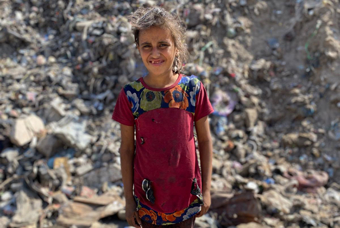 A young girl stands amonst the rubble of Al Ahli Arab Hospital in Gaza City